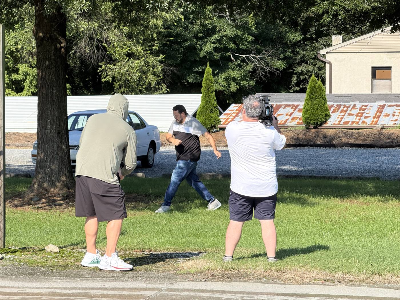 Brad mid-dance step as two cameras roll
