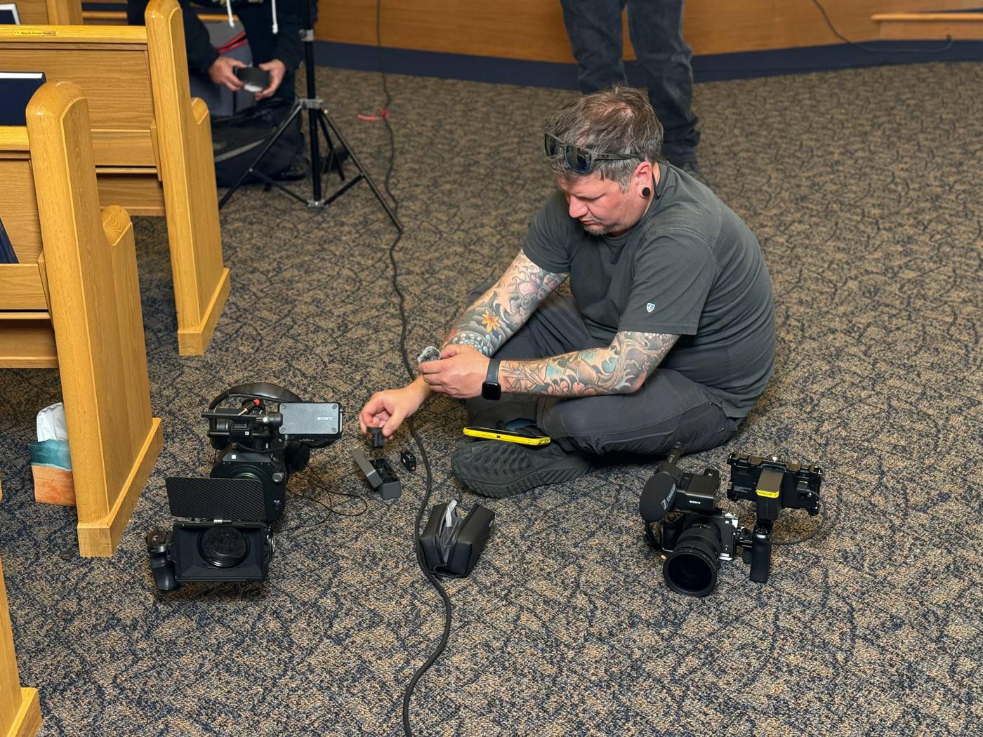 Jeff Irvin setting up a mic on set